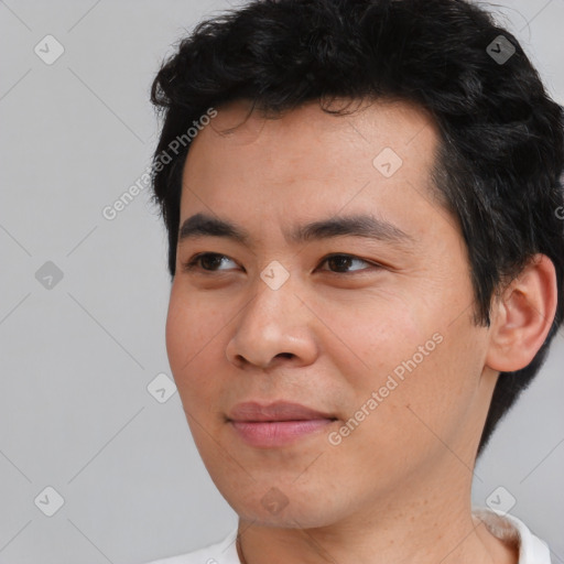 Joyful asian young-adult male with short  black hair and brown eyes