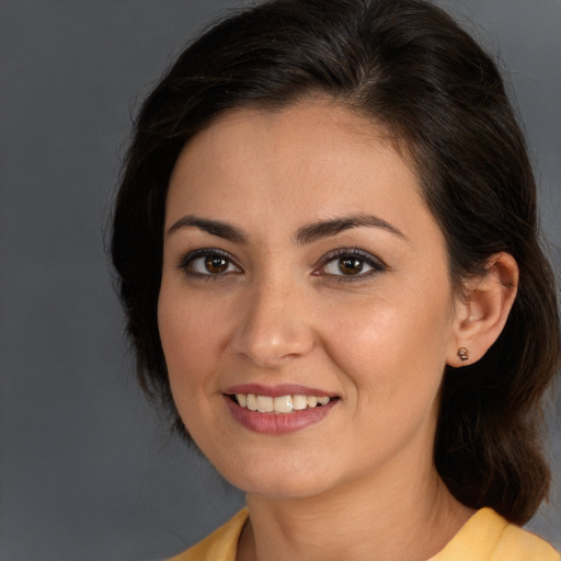 Joyful white young-adult female with medium  brown hair and brown eyes