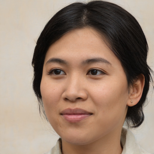 Joyful asian young-adult female with medium  brown hair and brown eyes