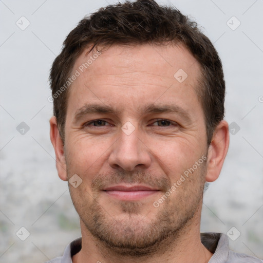 Joyful white adult male with short  brown hair and brown eyes