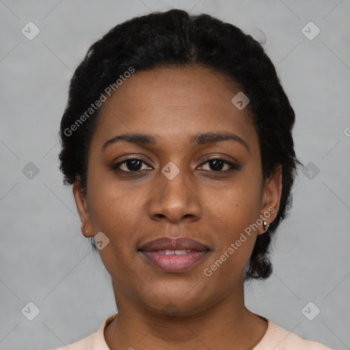 Joyful black young-adult female with short  black hair and brown eyes