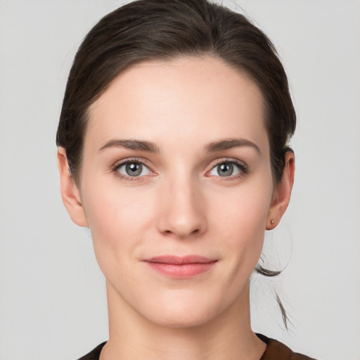 Joyful white young-adult female with short  brown hair and grey eyes