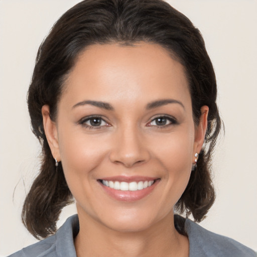 Joyful white young-adult female with medium  brown hair and brown eyes