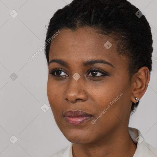 Joyful black young-adult female with short  black hair and brown eyes