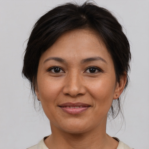 Joyful asian adult female with medium  brown hair and brown eyes