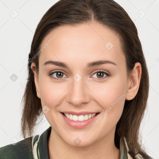 Joyful white young-adult female with long  brown hair and brown eyes