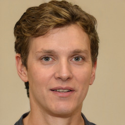 Joyful white adult male with short  brown hair and grey eyes