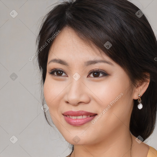 Joyful white young-adult female with medium  brown hair and brown eyes