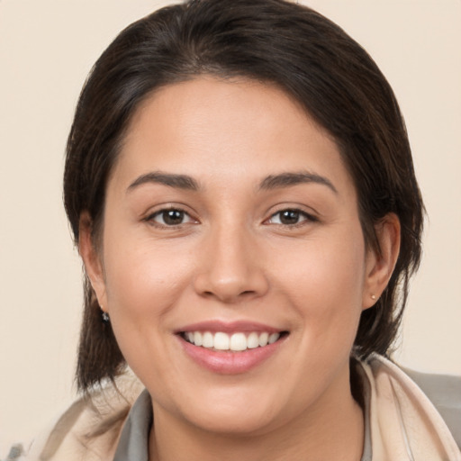 Joyful white young-adult female with medium  brown hair and brown eyes