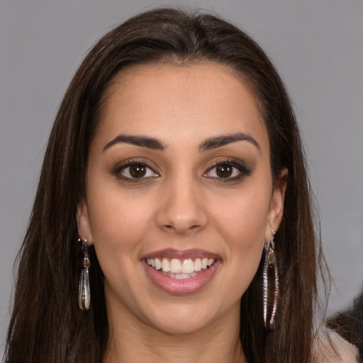 Joyful white young-adult female with long  brown hair and brown eyes