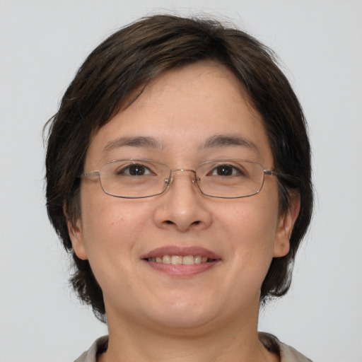 Joyful white adult female with medium  brown hair and brown eyes