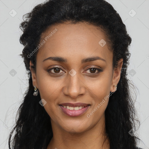 Joyful black young-adult female with long  brown hair and brown eyes