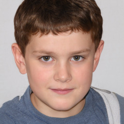 Joyful white child male with short  brown hair and brown eyes