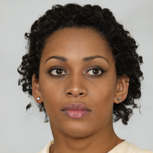 Neutral black young-adult female with medium  brown hair and brown eyes
