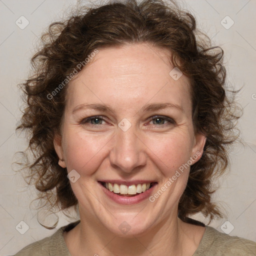 Joyful white adult female with medium  brown hair and blue eyes