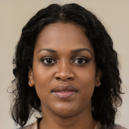 Joyful black young-adult female with medium  black hair and brown eyes
