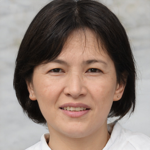 Joyful white adult female with medium  brown hair and brown eyes