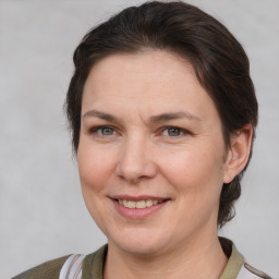 Joyful white adult female with medium  brown hair and brown eyes