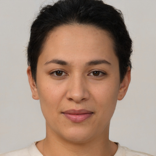 Joyful latino young-adult female with short  brown hair and brown eyes