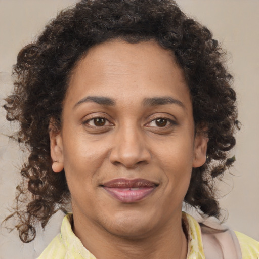 Joyful latino adult female with medium  brown hair and brown eyes