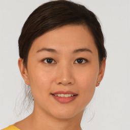 Joyful asian young-adult female with short  brown hair and brown eyes