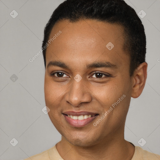 Joyful black young-adult male with short  brown hair and brown eyes