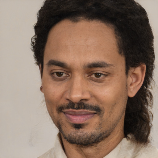 Joyful black adult male with short  black hair and brown eyes