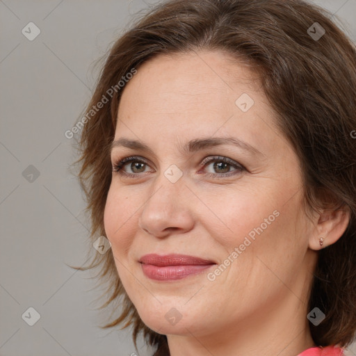 Joyful white adult female with medium  brown hair and grey eyes