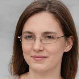 Joyful white adult female with long  brown hair and brown eyes