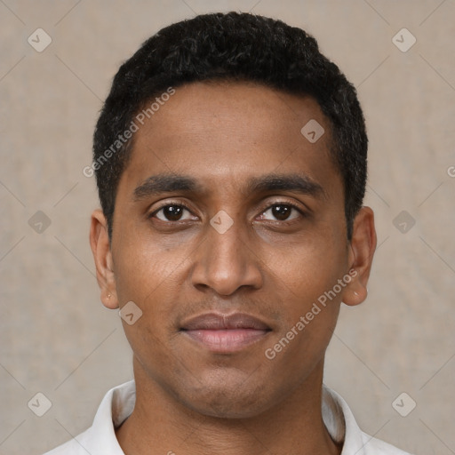 Joyful black young-adult male with short  black hair and brown eyes