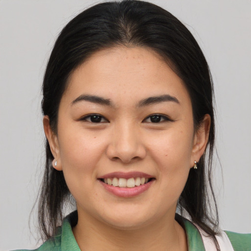 Joyful asian young-adult female with medium  brown hair and brown eyes