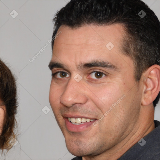 Joyful white adult male with short  brown hair and brown eyes