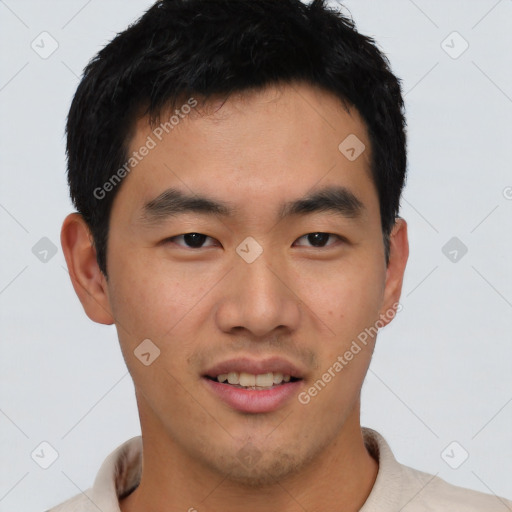 Joyful asian young-adult male with short  black hair and brown eyes