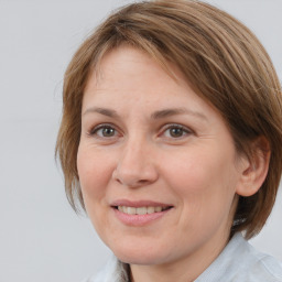 Joyful white adult female with medium  brown hair and brown eyes