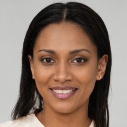 Joyful latino young-adult female with long  brown hair and brown eyes