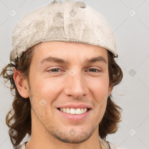 Joyful white young-adult male with medium  brown hair and grey eyes