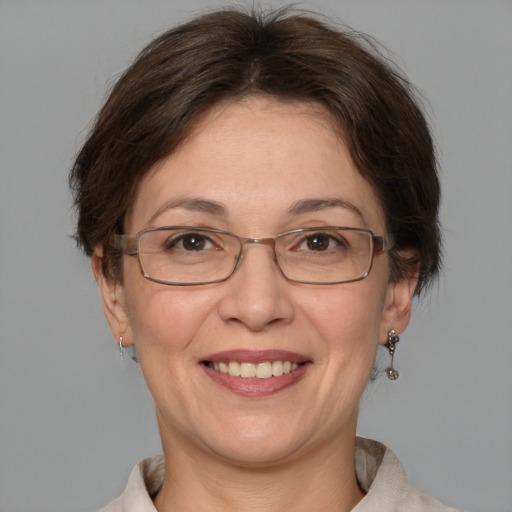 Joyful white adult female with medium  brown hair and brown eyes