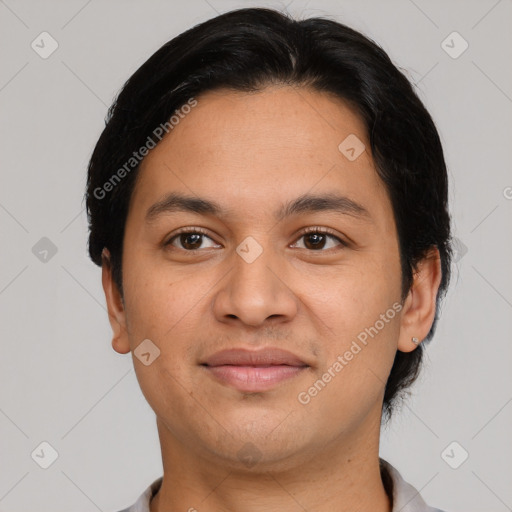 Joyful latino young-adult male with short  brown hair and brown eyes