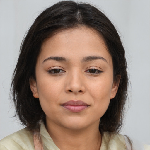 Joyful latino young-adult female with medium  brown hair and brown eyes