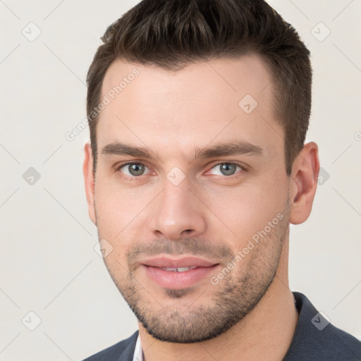 Joyful white young-adult male with short  brown hair and brown eyes