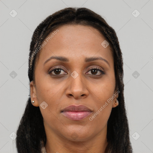 Joyful black adult female with long  brown hair and brown eyes