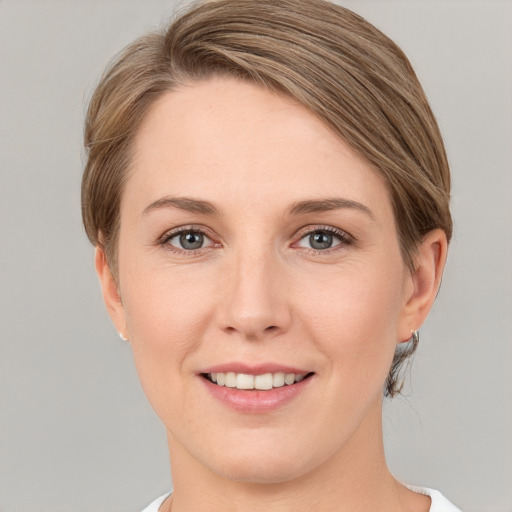 Joyful white young-adult female with medium  brown hair and grey eyes