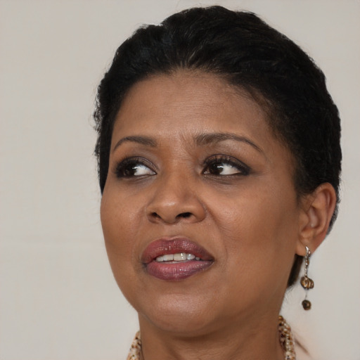 Joyful black adult female with short  brown hair and brown eyes