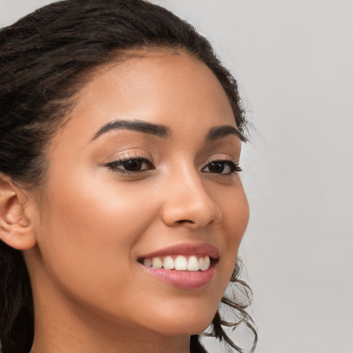 Joyful latino young-adult female with long  brown hair and brown eyes