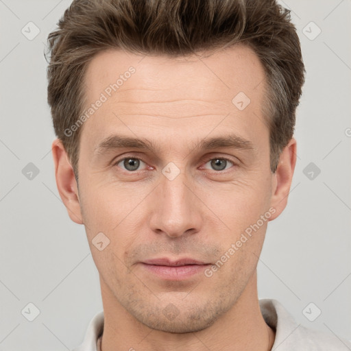 Joyful white adult male with short  brown hair and grey eyes