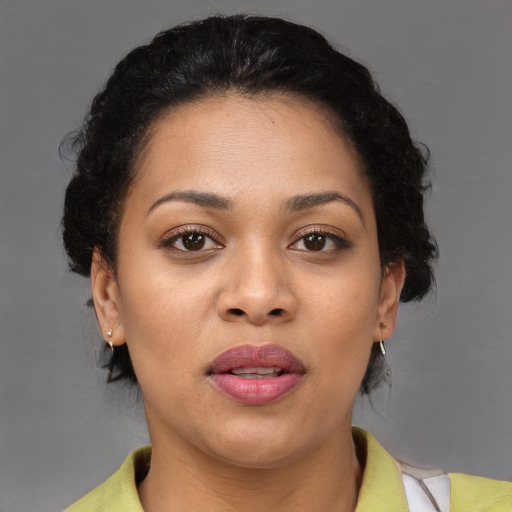 Joyful latino adult female with short  black hair and brown eyes