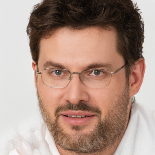 Joyful white adult male with short  brown hair and brown eyes