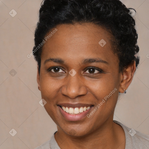 Joyful black young-adult female with short  black hair and brown eyes