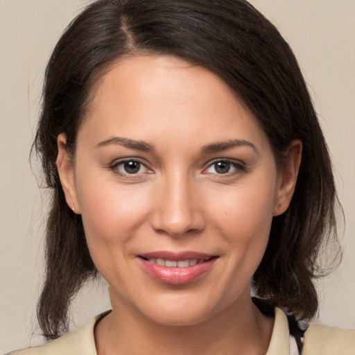 Joyful white young-adult female with medium  brown hair and brown eyes