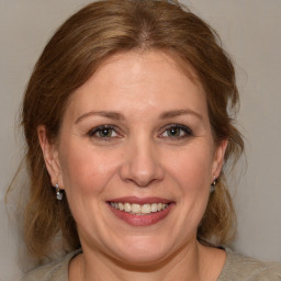 Joyful white adult female with medium  brown hair and brown eyes